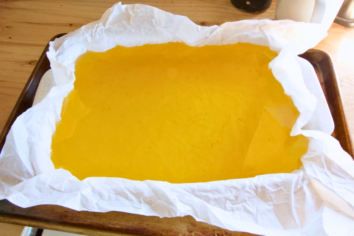 rendered beef tallow in a baking dish lined with parchment paper
