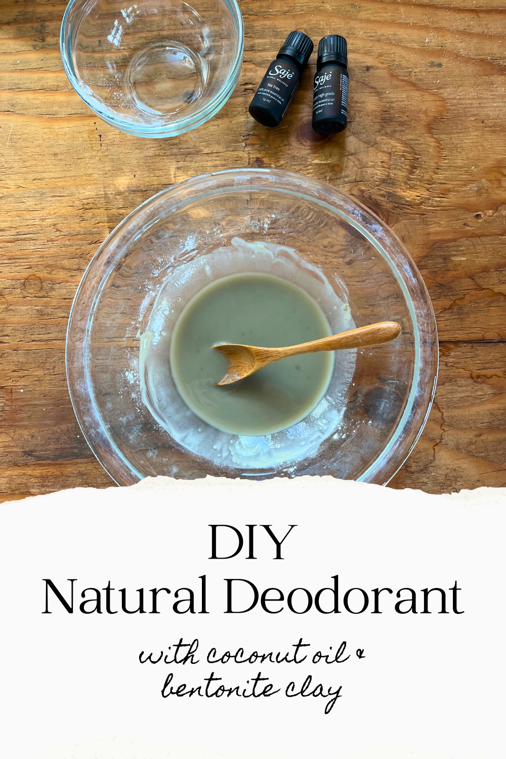 bowl of homemade deodorant on a counter with two small bottles of essential oils