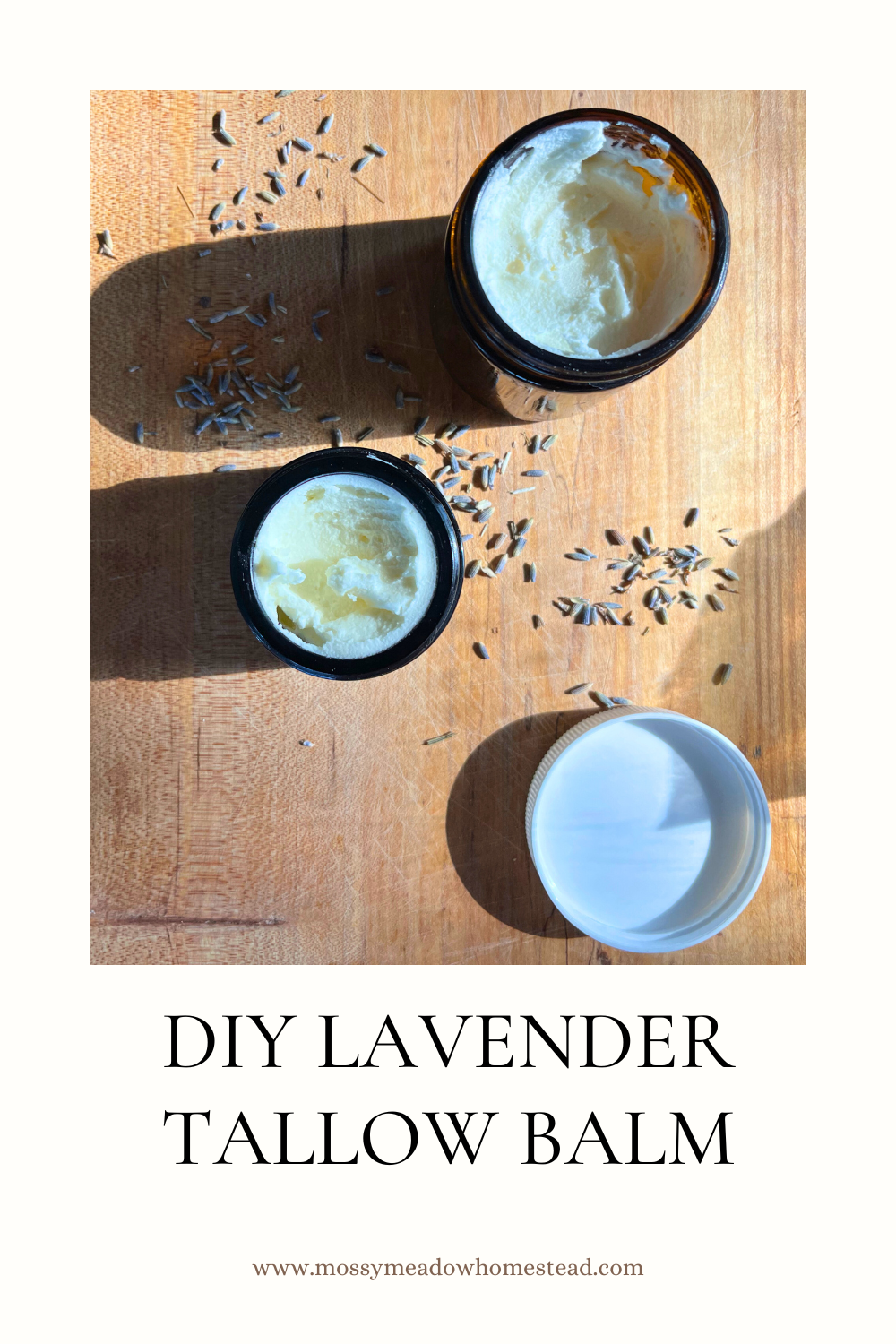 2 jars of lavender tallow balm on a wooden board with dried lavender sprinkled around it