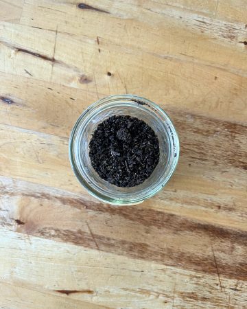 dehydrated, ground up vanilall beans in a ajar